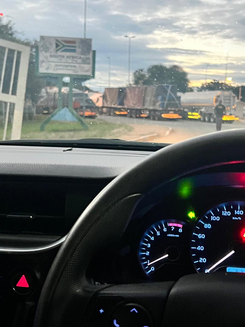 Dashboard view approaching a border crossing at dusk